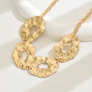 Irregular gold hammered metal necklace with geometric hollow oval pendant charms
