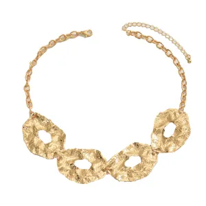 Modern gold necklace with four hammered irregular metal rings and adjustable clasp