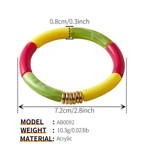 Detail view of colorful acrylic bamboo tube bracelet with marble texture and gold rings
