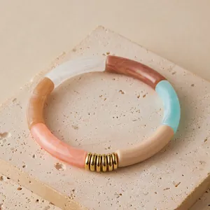 Colorful acrylic bamboo tube bracelets with gold metal spacers on minimalist stone