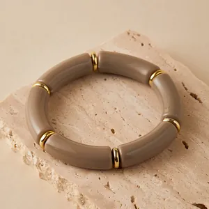 Dettaglio del bracciale in acrilico talpa con distanziali dorati su base in pietra