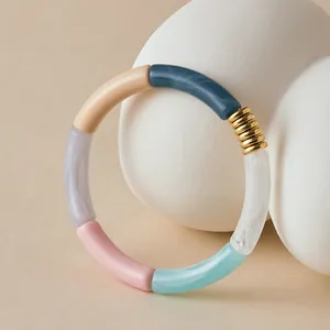 Colorful acrylic bamboo-style tube bracelet with a polished gold metal accent