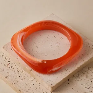 Chic irregular translucent orange marble resin bangle with a retro square design
