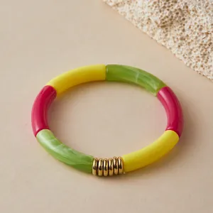 Detail of colorful resin tube bracelet with green marble texture and gold metal spacers