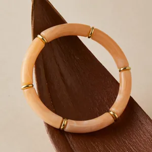 Bohemian elastic tube bracelet with apricot marble texture and gold metal spacers