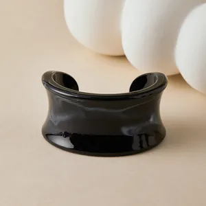 Macro detail of Bohemian resin cuff bracelet with black and white marble ink texture
