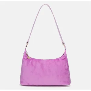 Close-up of purple faux fur handbag with leather strap and golden hardware accents