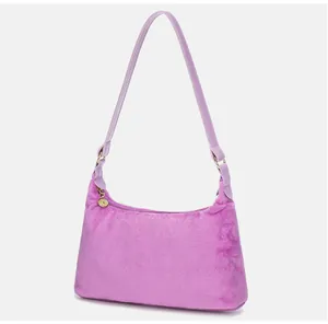 Detailed macro view of purple faux fur texture and smooth leather strap on underarm bag