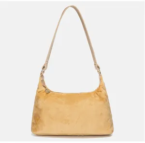 Close-up of yellow velvet hobo bag showing soft faux fur texture and zipper detail