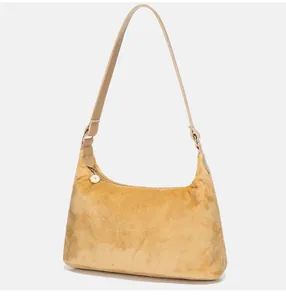 Detail of soft ginger yellow faux fur hobo bag with smooth leather strap and gold zipper