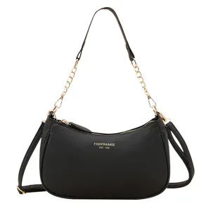 Chic black crescent underarm bag in litchi texture with golden chain strap and logo