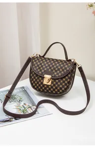 Detail of vintage brown quilted bag with gold metal buckle and geometric print
