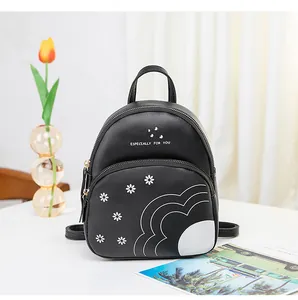 Close-up of black daisy print mini backpack with double zippers and wave patterns