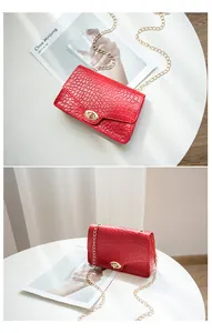 Vue détaillée du sac bandoulière rouge motif crocodile avec chaîne dorée et fermoir pivot