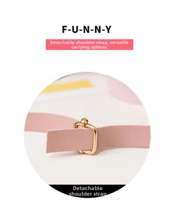 Close-up of pink leather detachable shoulder strap with golden metal buckle and texture