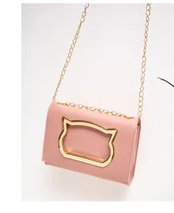 Detail of pink PU leather small square bag with golden cat head metal decoration