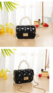 Detail view of black mini jelly bag with pearl handle and quilted pattern detail
