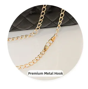 Macro detail of high-quality golden metal hook and chain strap on quilted leather bag