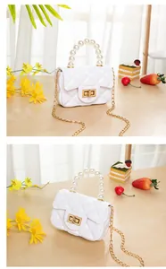 Detailed view of white quilted mini bag with pearl handle and gold twist lock