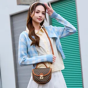 Retro brown semi-circle handbag with polka dot print and golden metallic clasp