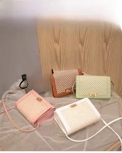Detail view of woven grid textured crossbody bags with elegant gold twist lock closures