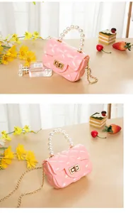 Detail of pink quilted jelly bag featuring pearl handle and golden twist lock closure