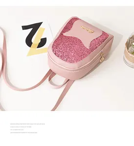 Detail of pink sequin mini backpack with gold metal plaque and premium leather texture