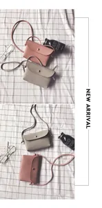 Detailed view of pink and grey litchi grain mini crossbody bags with gold round buckles