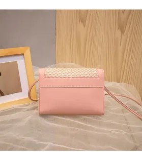 Detail of pink small crossbody bag featuring ivory mesh cutout and matte leather finish