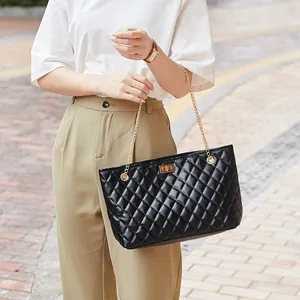 Chic black quilted tote bag with gold chain strap and turn-lock closure for women