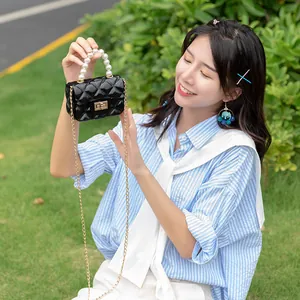 Mini black quilted jelly bag with pearl handle and gold chain strap for women