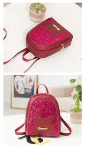 Detail of rose red sequin mini backpack featuring cat ears and leaf zipper pulls