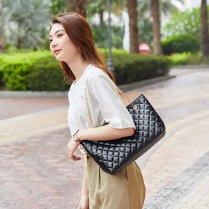 Classic black quilted tote bag with gold chain straps for large capacity shoulder use