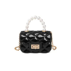 Mini black jelly bag with quilted pattern, pearl top handle and golden chain strap