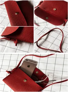 Detail view of mini red crossbody bag interior and texture with magnetic clasp