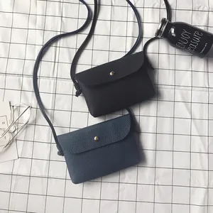 Mini crossbody phone bag for women in black and navy faux leather with a snap button