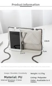 White quilted crossbody bag featuring metal V-logo and fringe with iPhone for scale