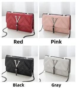Detailed view of quilted faux leather shoulder bags in red, pink, black, and grey options