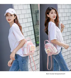 Detail of a mini pink and white dual-use backpack with a gold square buckle