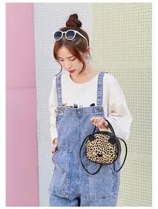 Detailed view of leopard print cat-shaped crossbody bag with decorative ears and whiskers