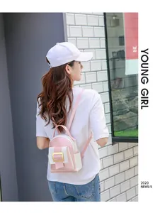 Detailed back view of a pink and beige mini contrast-color backpack with gold metal clasp