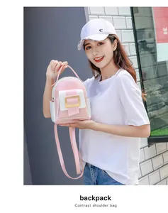 Detail of a mini pink and white contrast backpack with a stylish gold square buckle lock