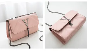 Detail view of pink quilted shoulder bag with silver V logo and metal tassel chain