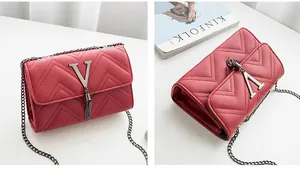 Macro detail of red chevron quilted shoulder bag with V metal hardware and tassel