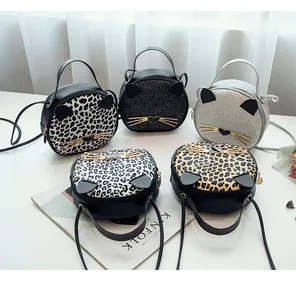 Detail view of cat ear crossbody bags in leopard print and glitter finishes for women