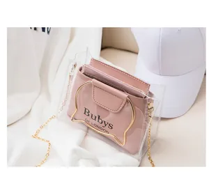 Detail of transparent PVC crossbody bag with pink inner pouch and cat-ear metal handles