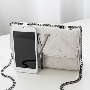 Chic cream white V-quilted crossbody bag with metallic chain strap and fringe tassel