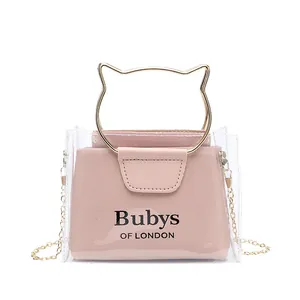 Transparent PVC mini crossbody bag with pink leather pouch and gold cat-ear handles