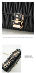 Close-up of golden S-logo metal clasp and chain strap on black quilted crossbody bag