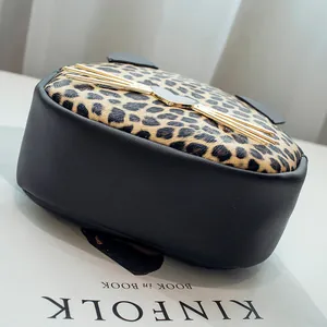 Chic leopard print and black leather crossbody bag with cute cat ear details and gold hardware